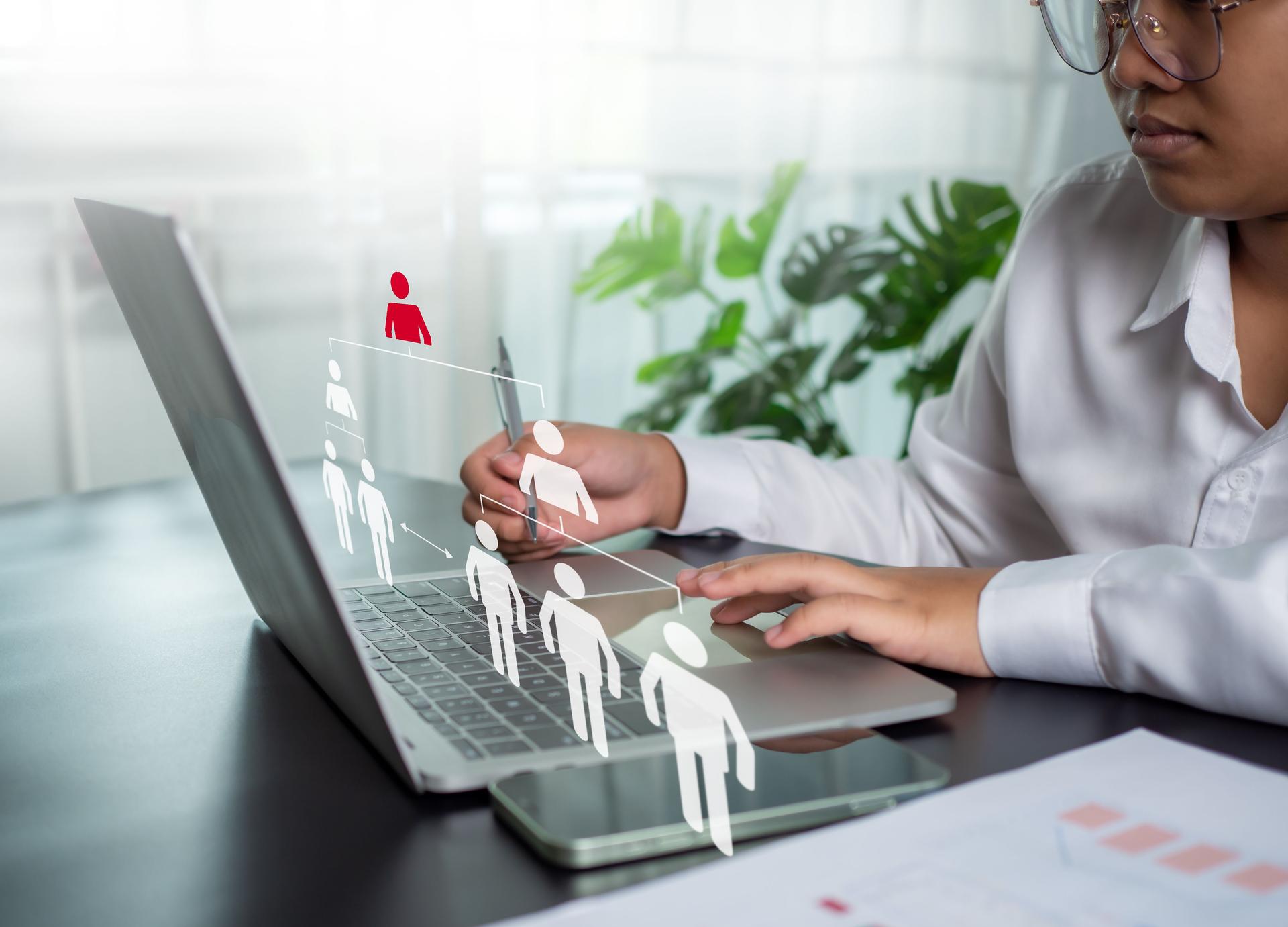 Businesswoman using computer to manage human resources of organization as a business concept and HR concept for leaders and team leaders.